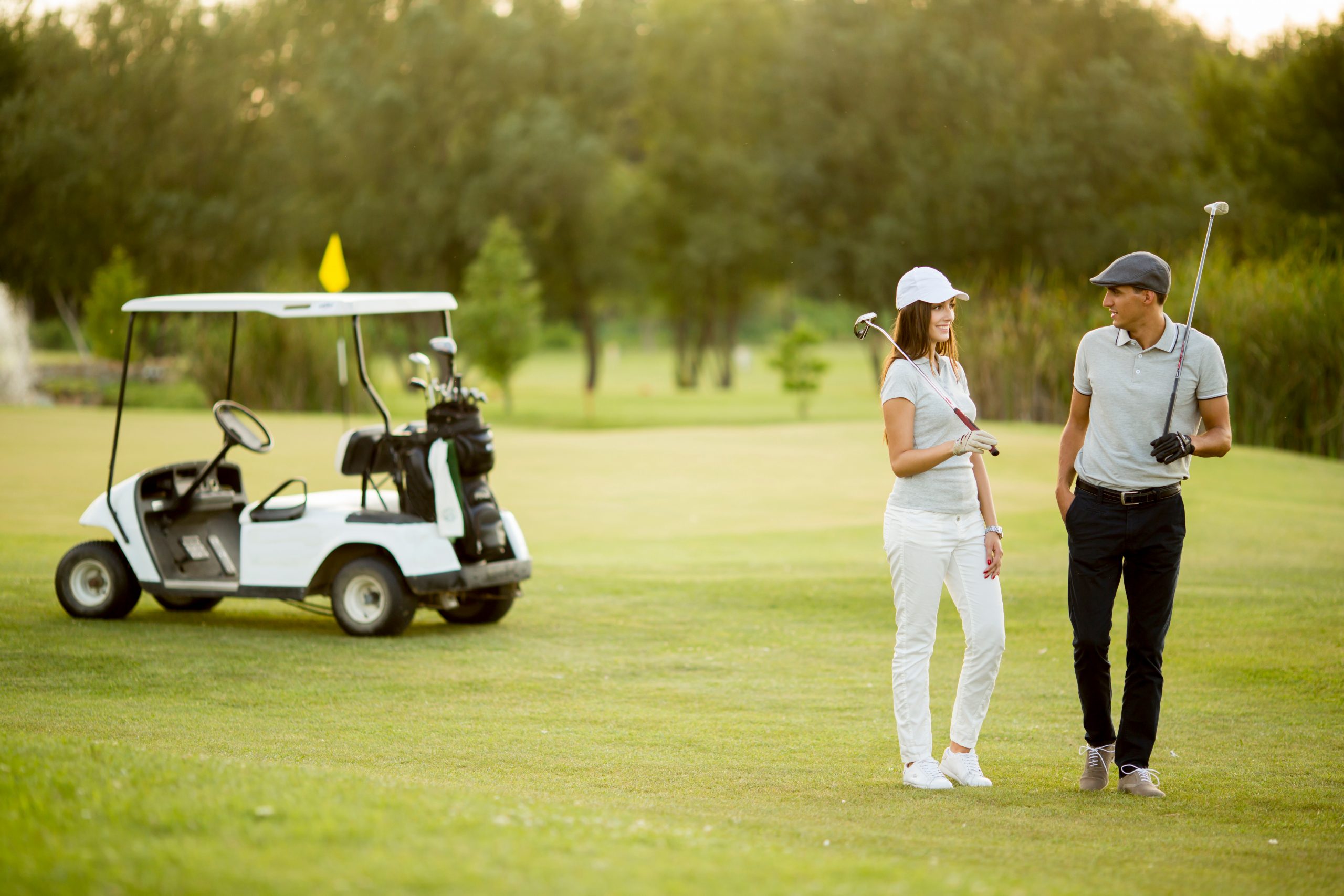 Young couple at golf cart